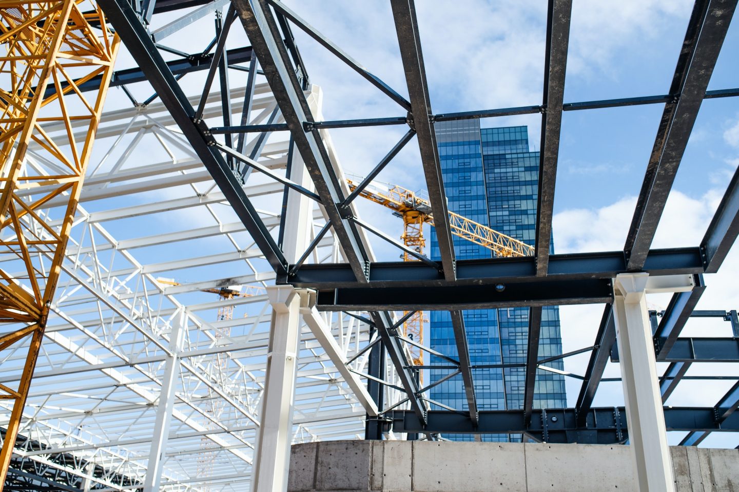 Construction site with steel frame structure and crane